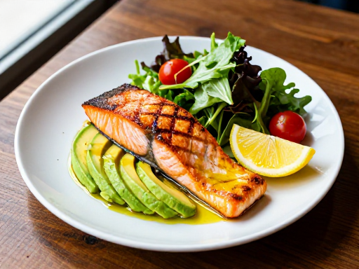 Delicious keto meal with grilled salmon, avocado, and fresh greens